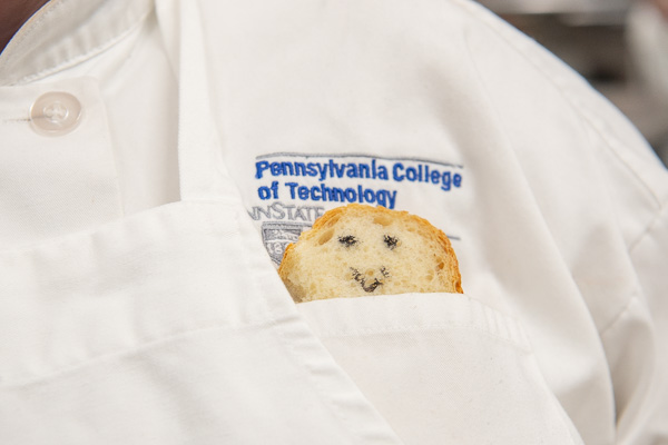 “Bread baby” rests in a student’s pocket in the baking lab. 