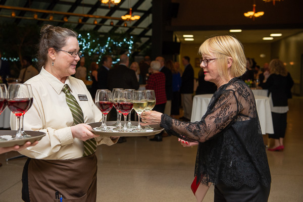 Hospitality management student Jeanne L. Booth offers refreshment at the reception. 