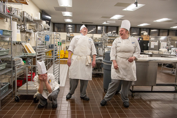 Kitchen shenanigans: After an impromptu dance, baking and pastry arts students burst into laughter. From left are Gloria F. Boronow, Tyler C. Geer and Madeline J. Novack. 