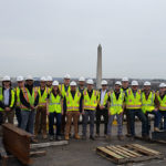 With the U.S. Capitol and Washington Monument behind them, the group poses atop Hensel Phelps' renovations to the Martin Federal Reserve Building in downtown Washington, D.C.