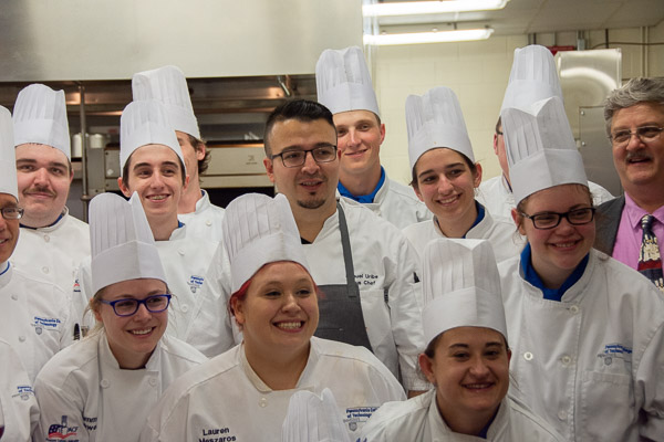 Uribe celebrates with students as food preparation is concluded and front-of-house staff deliver the dessert course.