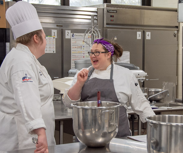 Erceg brings joy to a conversation with student Madeline J. Novack as they prepare breads for the Visiting Chef Dinner.