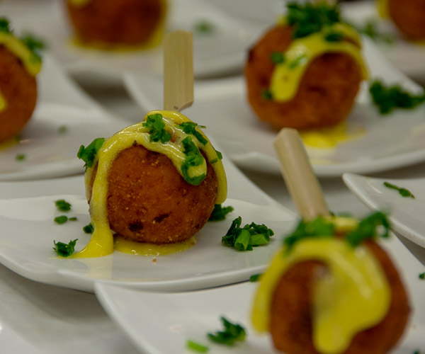 Among the hors d’oeuvres served before guests were seated is arancini (small balls of rice fried in bread crumbs) with aioli.