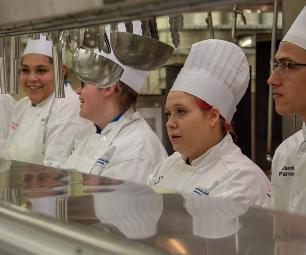 Between courses, culinary arts students await their next call to action.