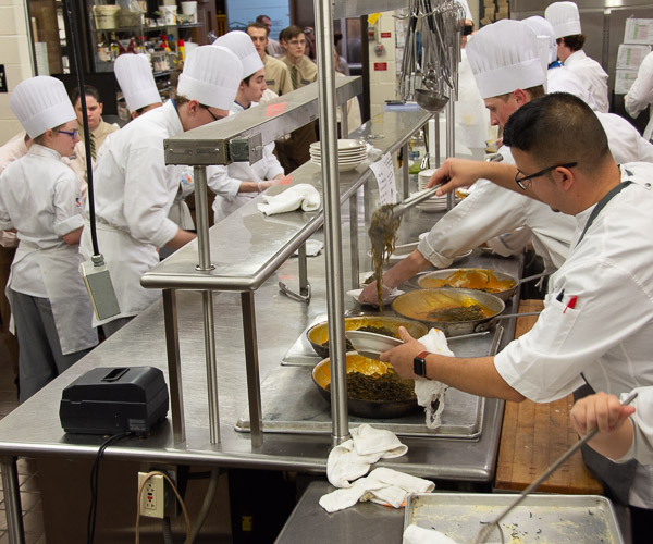 For the second course, students join Uribe (far right) in serving up the world championship pasta dish, fresh off the stove.