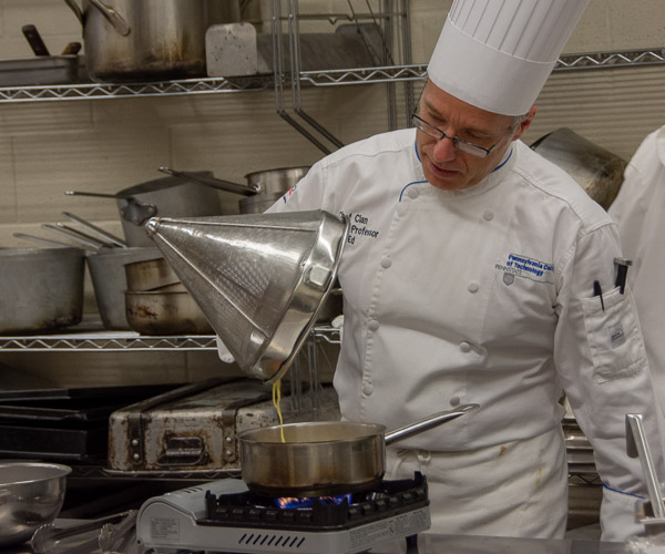 Chef Craig A. Cian, associate professor of hospitality management/culinary arts, prepares a special order.