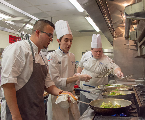 Uribe and students Kobi A. Shannon, of Lewistown, and Aaron Timmons, of Greencastle, prepare Romanesco for the main course.