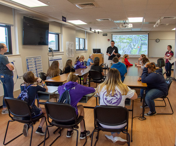 David E. Bjorkman, instructor of emergency management/social science, helps students to understand the role of an emergency operations center during a disaster.