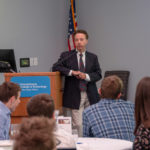 Roy A. Fletcher, assistant professor of business administration/banking and finance, talks with the group about both the history and future of artificial intelligence in the financial markets.