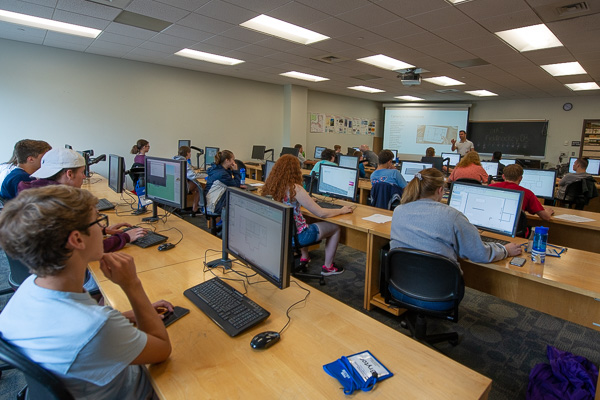 A full house in an architecture lab with Naim N. Jabbour (at front), assistant dean of construction and design technologies, offering insights into the profession.  