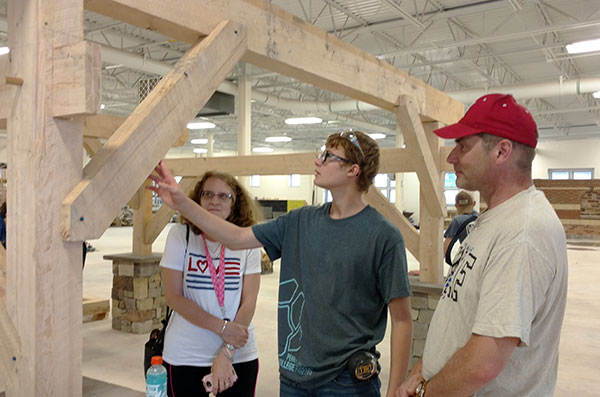 A construction camper shows off his work as parents visit on the final day. (Photo by Carol A. Lugg, dean of construction and design technologies)