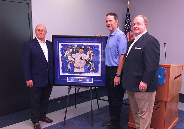 Little League International Board Chair Hugh E. Tanner (right) joins artist Fred Gilmour (left) and Mussina alongside a composite painting.