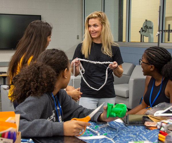 Abbey Flick, one of four area educators who served as mentors for SMART Girls, provides tips on making “scrunchies.”