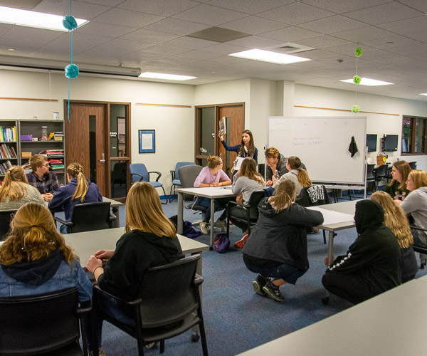 Jillian T. Scanlon, instructor of early childhood education, leads visitors in creating a hands-on lesson for preschool children.