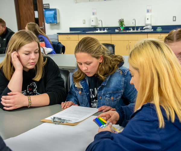 Visitors collaborate to develop a hands-on lesson for preschoolers.