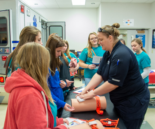 Sarah C. Gagnon, a paramedic technician student from Jersey Shore, shows students how to “stop the bleed” by applying tourniquets and packing wounds with gauze.