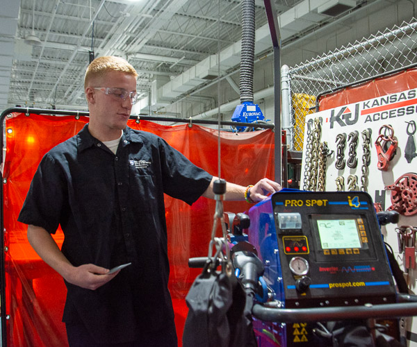 Collision repair technology student Nick J. Sida, of Johnstown, shows a Pro Spot i4 inverter spot welder …