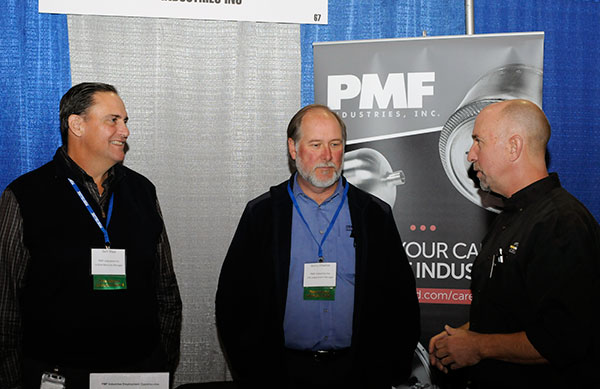 In addition to students and alumni, faculty enjoy networking opportunities with Career Fair exhibitors. Richard K. Hendricks Jr. (right), instructor of automated manufacturing and machining, talks with Sam Shea (left) and Gerry Ulsamer, of PMF Industries Inc.