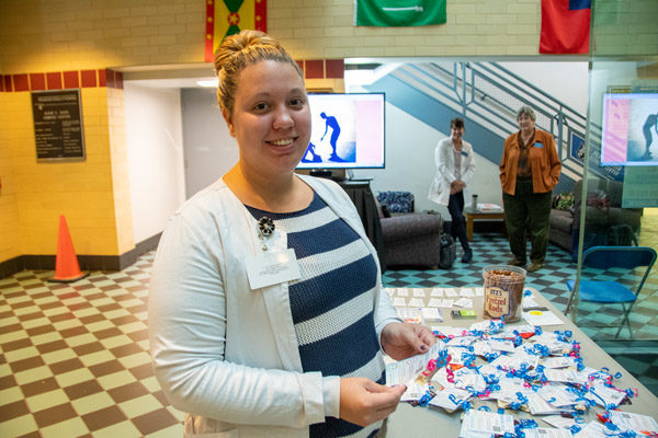 Samantha Stahl, of Milton, shows helpful handouts to be distributed in the Campus Center.