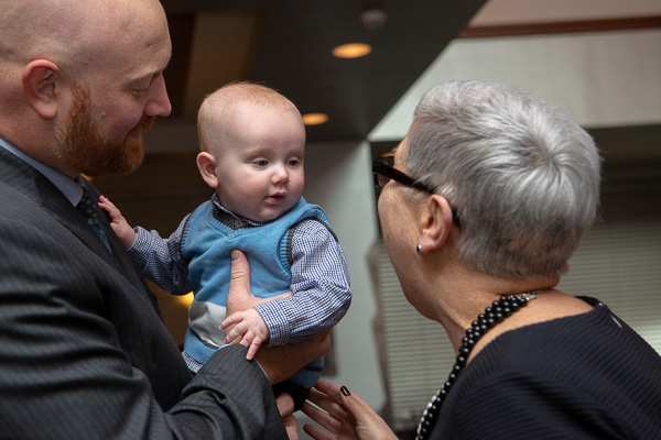 The alumni honoree's youngest son meets President Gilmour. 