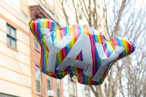 A congratulatory balloon floats above the crowd outside the CAC. 