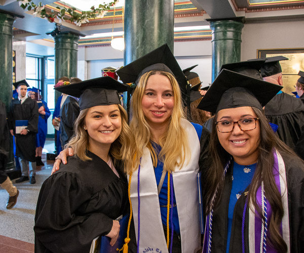 Nursing graduates Kalee M. Hart, of Bloomsburg; Daria Datsenko, of Lewisburg; and Genevieve F. Guzman, of Pottsville, stick together after the ceremony.