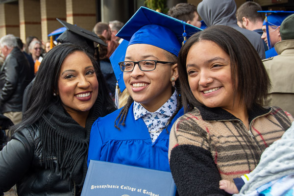 Aniah T. Ellerbee, a building construction technology graduate from Tannersville, commemorates the day with her family.