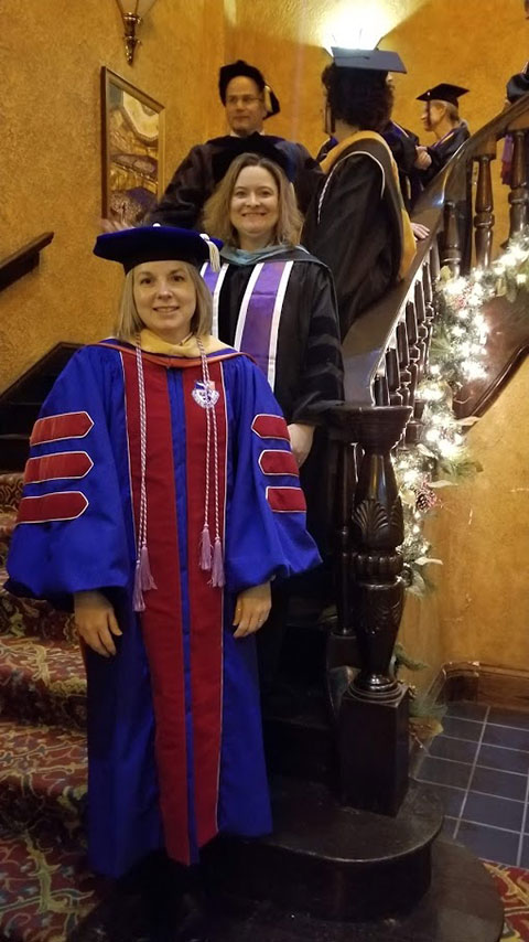 Among those preparing to process into the theater are Sandra L. Richmond (foreground), dean of nursing and health sciences, and Valerie A. Myers, assistant dean of nursing.