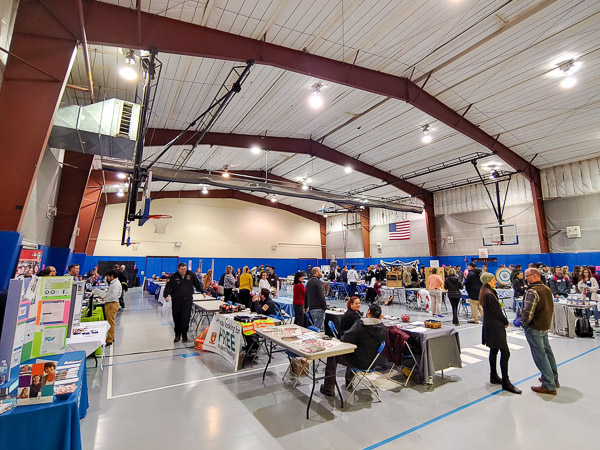 Tables fill the Field House in an informative array.