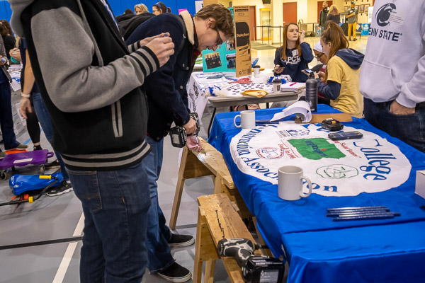 True to their majors' hands-on focus, the Penn College Construction Association allows visitors to test their power-drilling skills.