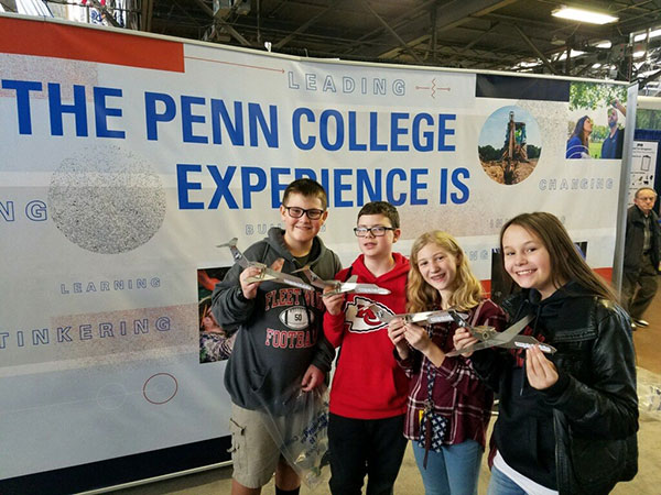 Sixth-graders from Fleetwood Area Middle School in Berks County proudly show off their keepsake aircraft, some of the 70 or so built at the college's booth that day.
