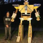 Scott F. Bennardi, Williamsport, a welding and fabrication engineering technology major from Williamsport, stands in the shadow of his imposing creation.