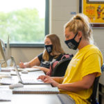 Graphic design student Abigail “Abby” C. Williams (in foreground) works in a Bush Campus Center lab. 