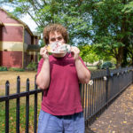 David H. Jamison prepares to display his mask (“Let’s Stay Safe”) on The Victorian House fence. Jamison, from Chambersburg, is enrolled in information technology: network specialist concentration. 