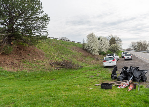 A fleet of GS vehicles lines the berm, along with some of the random refuse gathered Wednesday morning. Among the haul? A pylon, signposts, lumber and a tire.