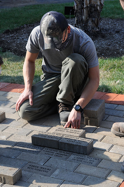 Lee reviews the tentative arrangement of bricks prior to their final placement.