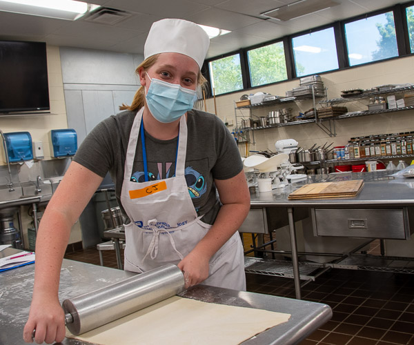 A participant rolls out puff pastry for egg tarts. The afternoon’s “work” also included fortune cookies – an advanced skill.