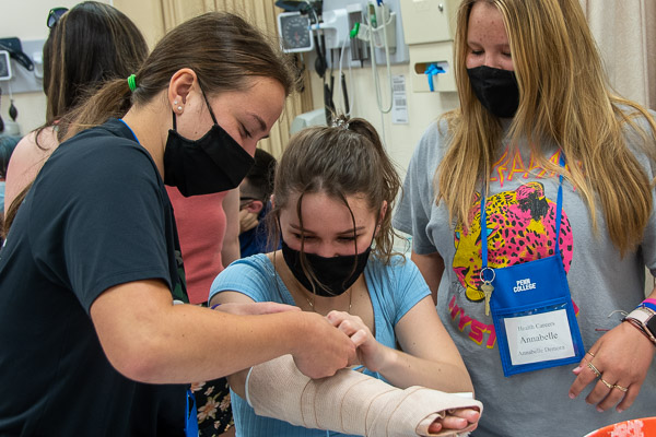 In the physician assistant lab, visitors try their hands at casting.
