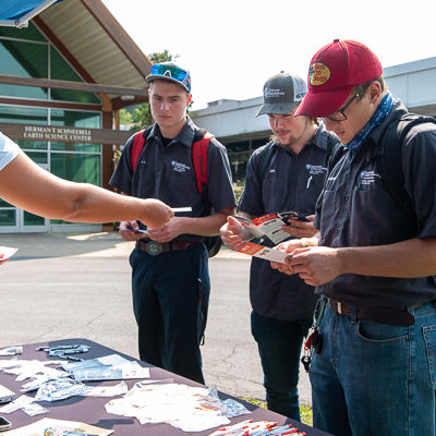 Bobcat looking for Wildcats: Daniela Bolivar, recruiting specialist with Crownstone Equipment/McGrew Equipment hands over her business card to prospects. The companies, focused on Bobcat and a diverse line of equipment, are located in southcentral Pennsylvania and northern Maryland. 