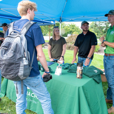 Joseph C. Moore (right), a 2020 graduate of heavy construction equipment technology: operator emphasis, leads the discussion for Brubacher Excavating Inc.