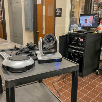 An Aver VC520 portable conference camera and sound system, set up in a Hager Lifelong Education Center hospitality lab by Audio/Visual Services, allows Chef Fabrizio Facchini (on monitor) to direct a culinary arts class from his kitchen in New York.