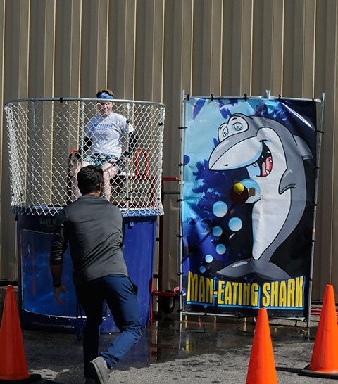 Wrestling coach Jamie R. Miller hits his mark dead-on at the dunk tank, where Wildcat shortstop Maggie J. Mangene took several dips for a good cause. Penn College's Student Athlete Advisory Committee ran the popular attraction as a fundraiser for Special Olympics, collecting $61 in the first hour alone.