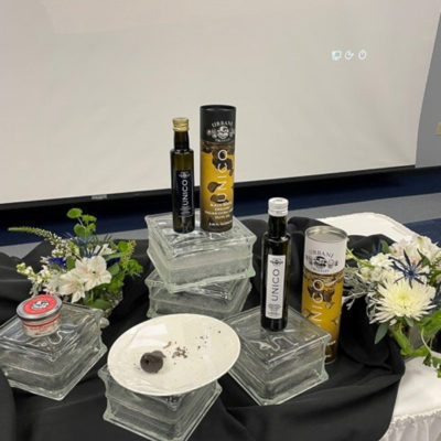 Chef Mary G. Trometter, assistant professor of hospitality management/culinary arts, sets an attractive display of truffle products, donated by Urbani Truffles, in the Thompson Professional Development Center, where, with the help of Audio/Visual Services, Facchini and Sabrina Notarnicola, of Urbani, taught students about truffles from a distance.