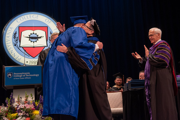 ... merits a hug as the president's 20,000th commencement handshake.