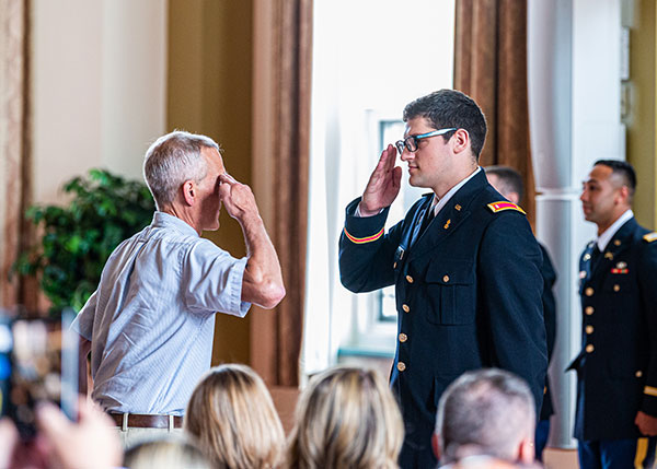 Army veteran John M. Good III, instructor of automated manufacturing and machining, presents the “first salute” to Samuel T. Van Dermark, of Penn Yan, New York. Van Dermark graduated with a bachelor’s degree in manufacturing engineering technology and associate degrees in automated manufacturing technology and machine tool technology. He will serve in the Army Reserve.