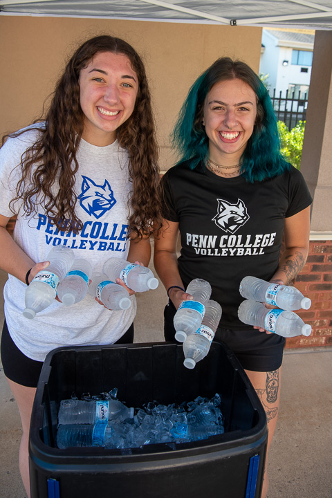 Wildcat volleyball players Hailey J. DeBrody (left) and Cheyenne E. Stein help refresh the masses with bottled water, always in demand on move-in day.