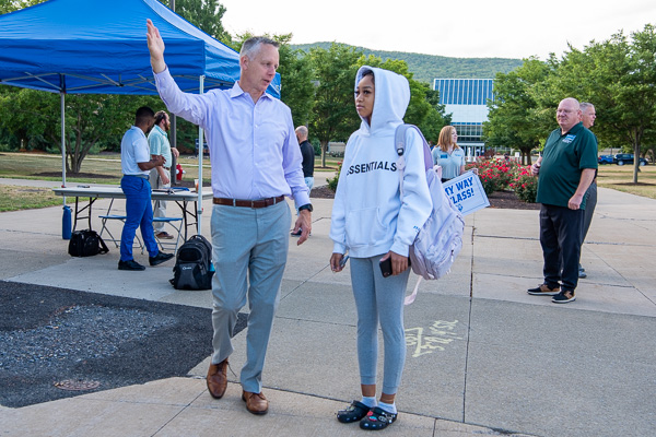 Directions from the top! Mikayla L. Williams, an architecture student from Philadelphia, receives guidance from President Reed on the location of her first class in the Hager Lifelong Education Center.