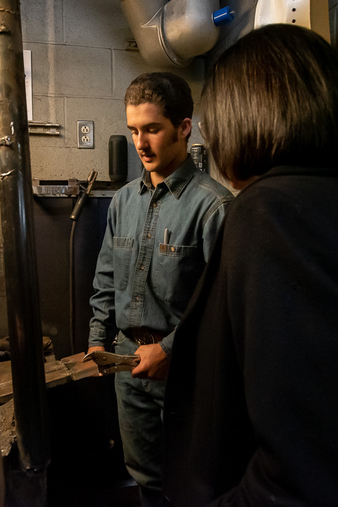 The special guest steps into a welding booth, where welding & fabrication engineering technology student John C. Mylin, of Bloomsburg, shows her a project on which he is working.