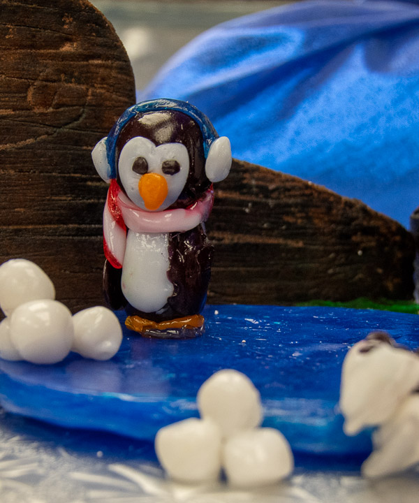 A blown-sugar penguin in an edible winter wonderland, crafted by Hannah L. Fleischer.