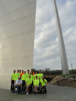 The group stands beneath the Gateway Arch in St. Louis during a stopover on the way home.